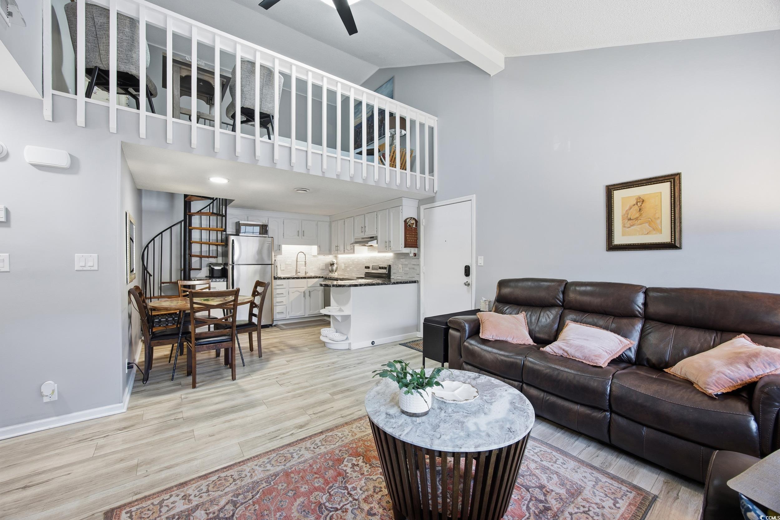 1200 Benna Drive, Unit 1C Myrtle Beach, SC 29577 - Photo 11 of 37 Living room with stairway, beam ceiling, light wood-style floors, high vaulted ceiling, and ceiling fan