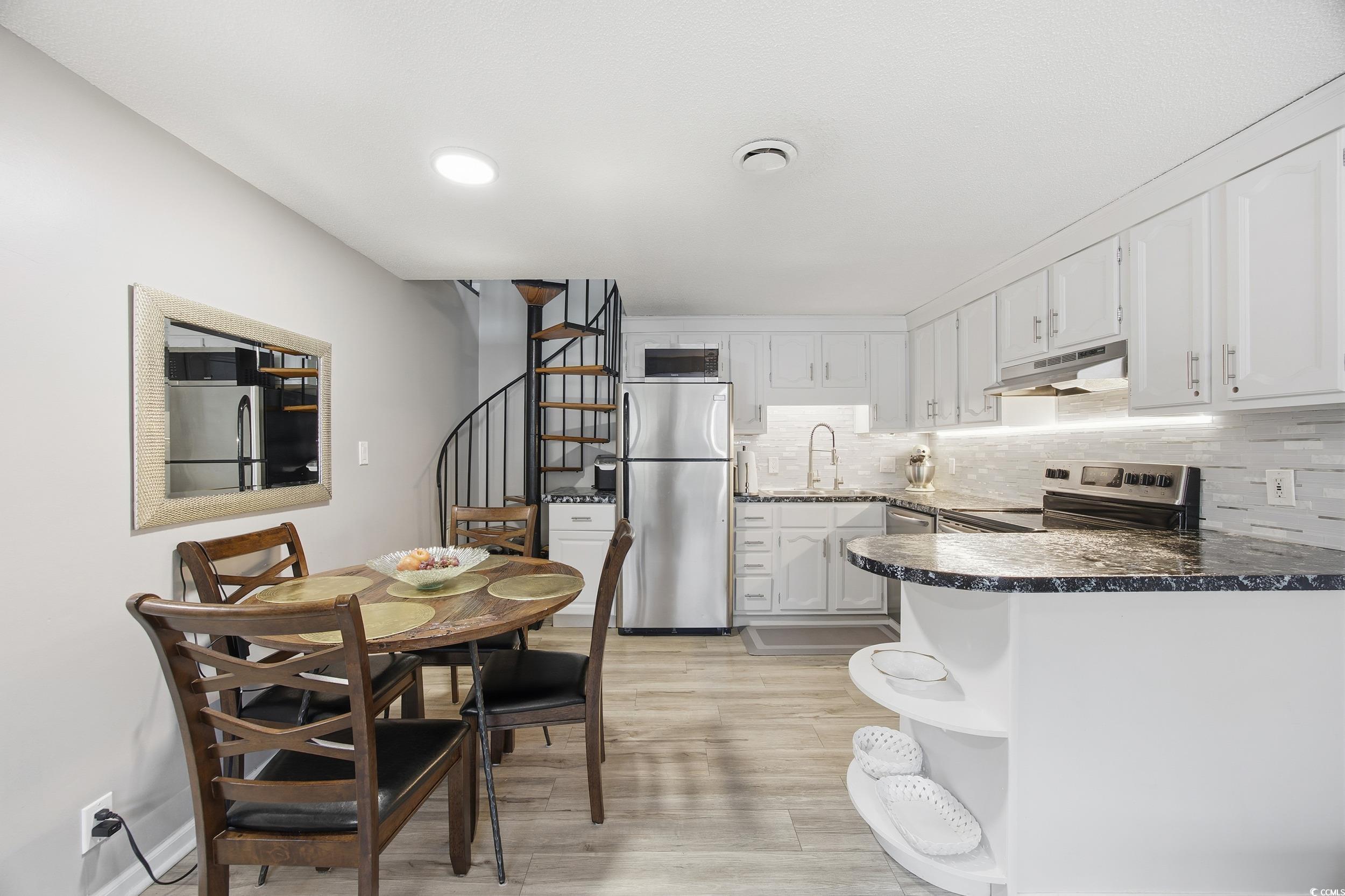 1200 Benna Drive, Unit 1C Myrtle Beach, SC 29577 - Photo 12 of 37 Kitchen featuring backsplash, open shelves, white cabinets, stainless steel appliances, and light wood-type flooring
