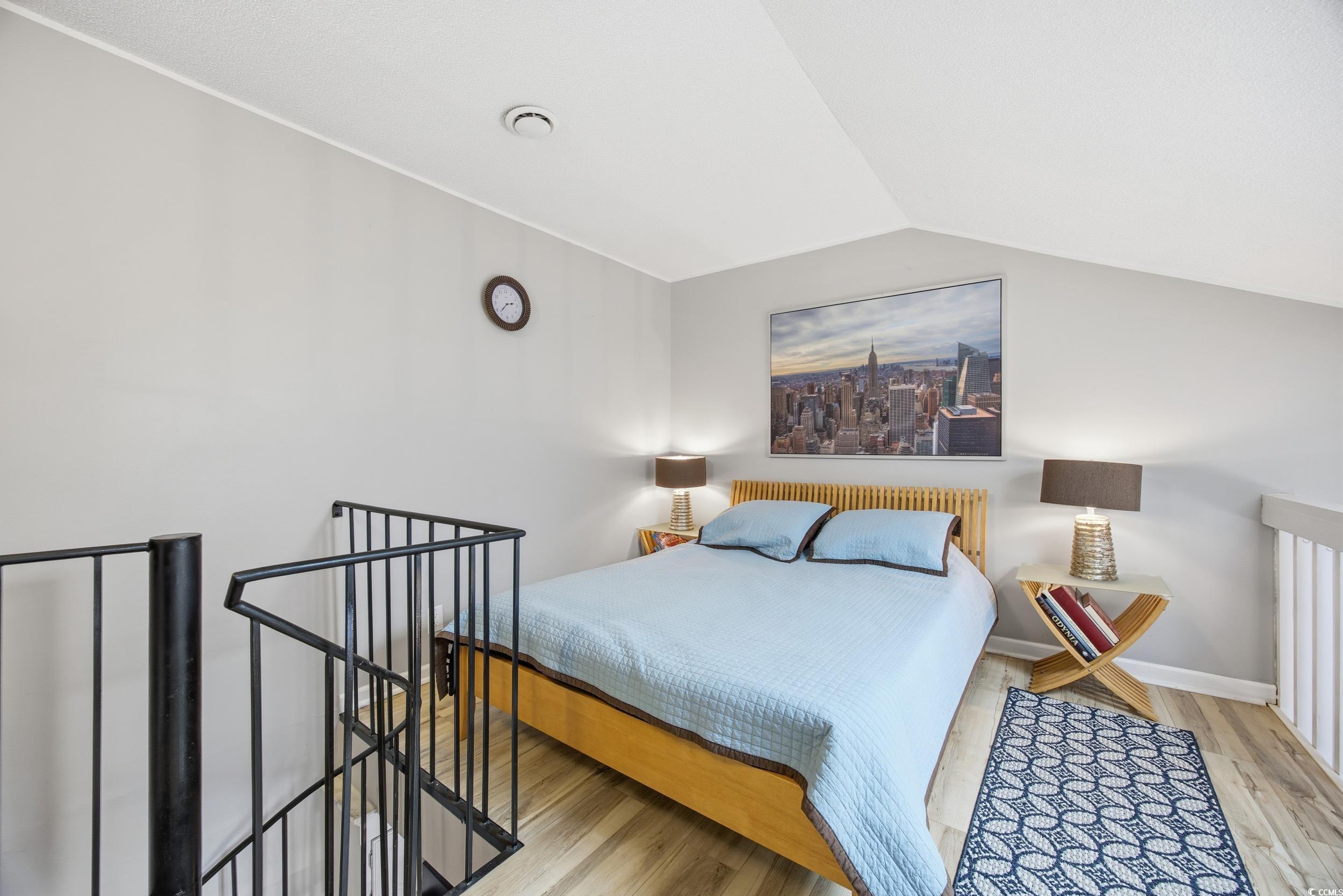 1200 Benna Drive, Unit 1C Myrtle Beach, SC 29577 - Photo 16 of 37 Bedroom with wood finished floors and lofted ceiling