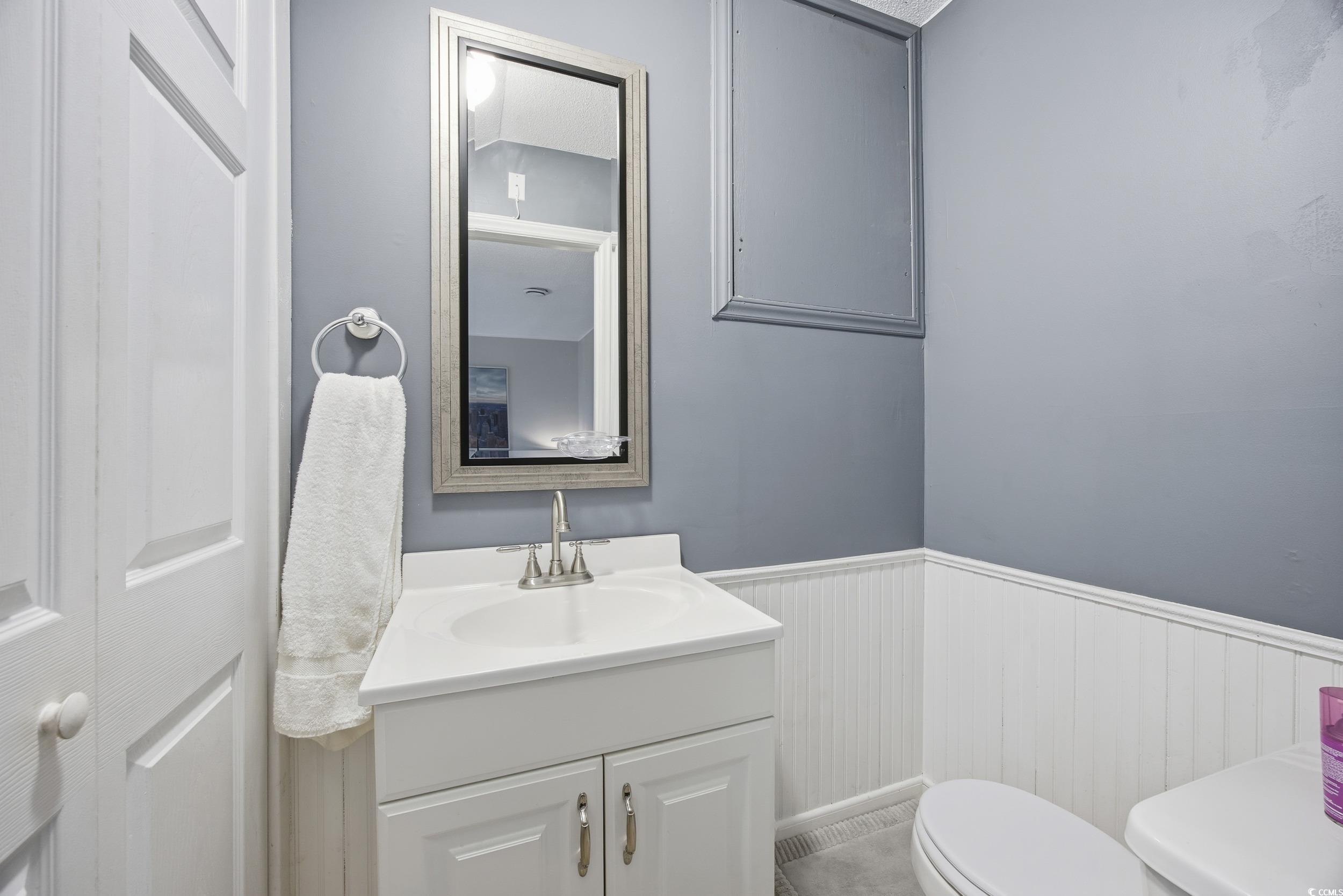 1200 Benna Drive, Unit 1C Myrtle Beach, SC 29577 - Photo 18 of 37 Bathroom with wainscoting and vanity