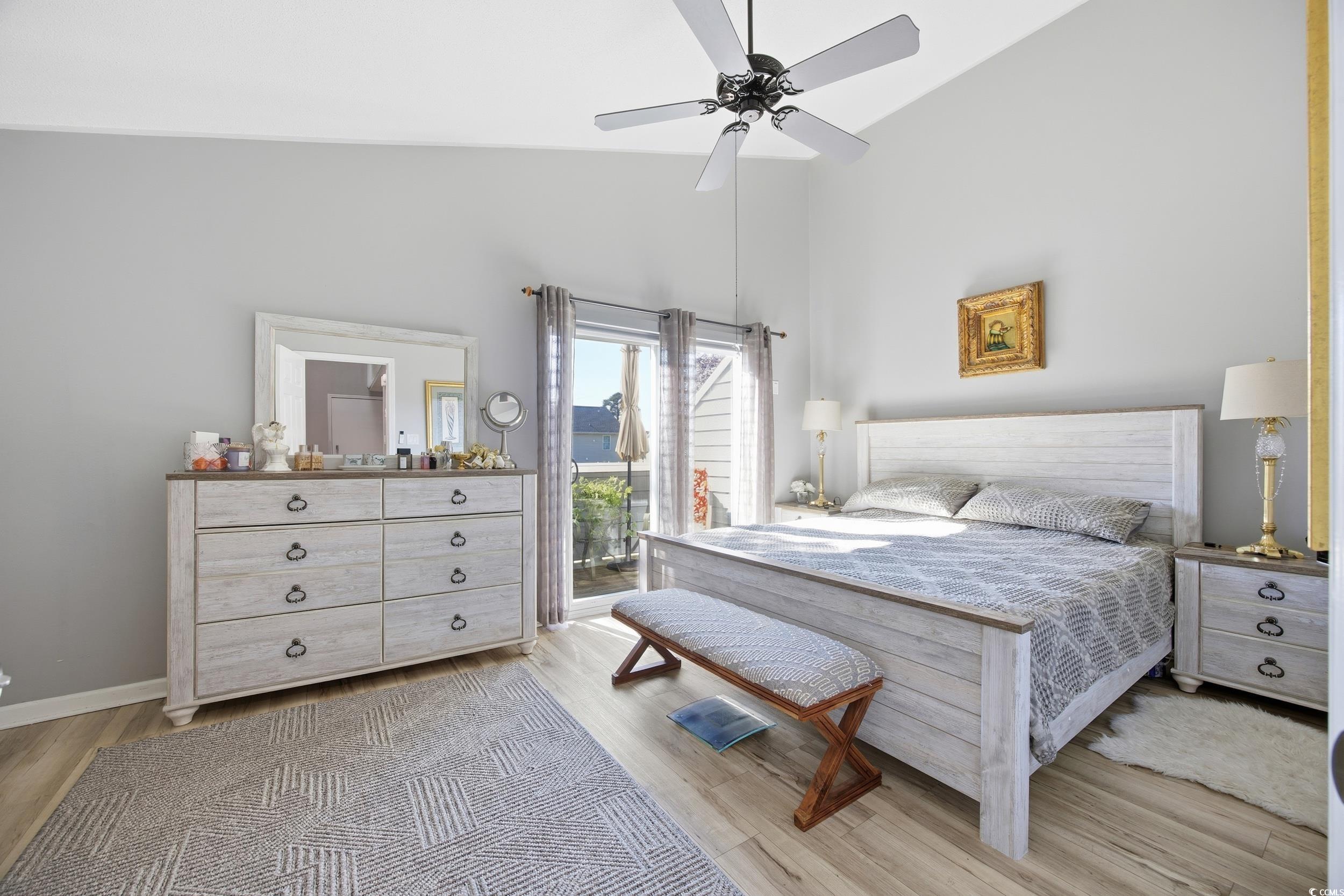 1200 Benna Drive, Unit 1C Myrtle Beach, SC 29577 - Photo 19 of 37 Bedroom featuring light wood-style flooring, access to outside, high vaulted ceiling, and ceiling fan