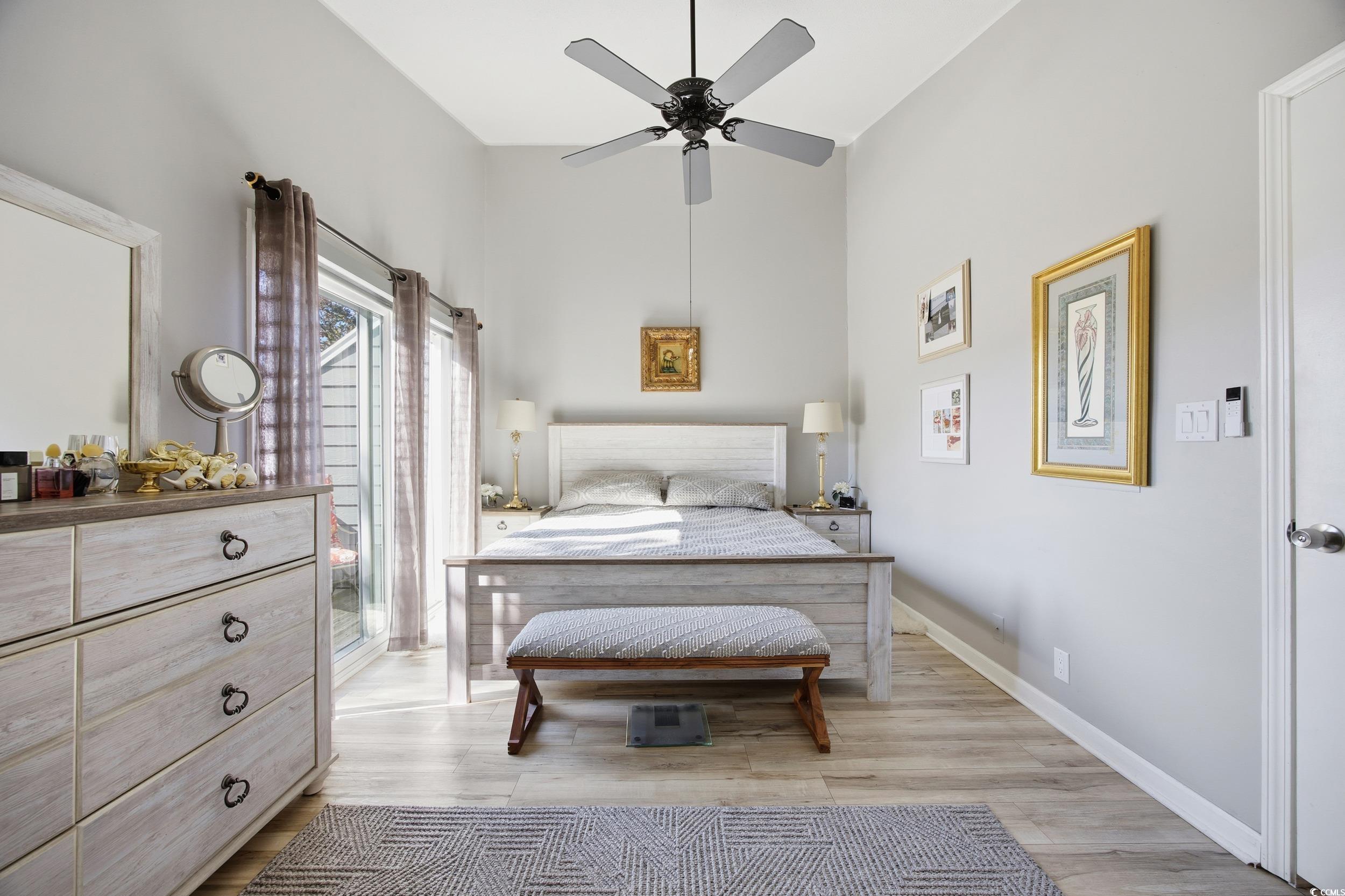 1200 Benna Drive, Unit 1C Myrtle Beach, SC 29577 - Photo 20 of 37 Bedroom featuring light wood-style floors, a high ceiling, and a ceiling fan