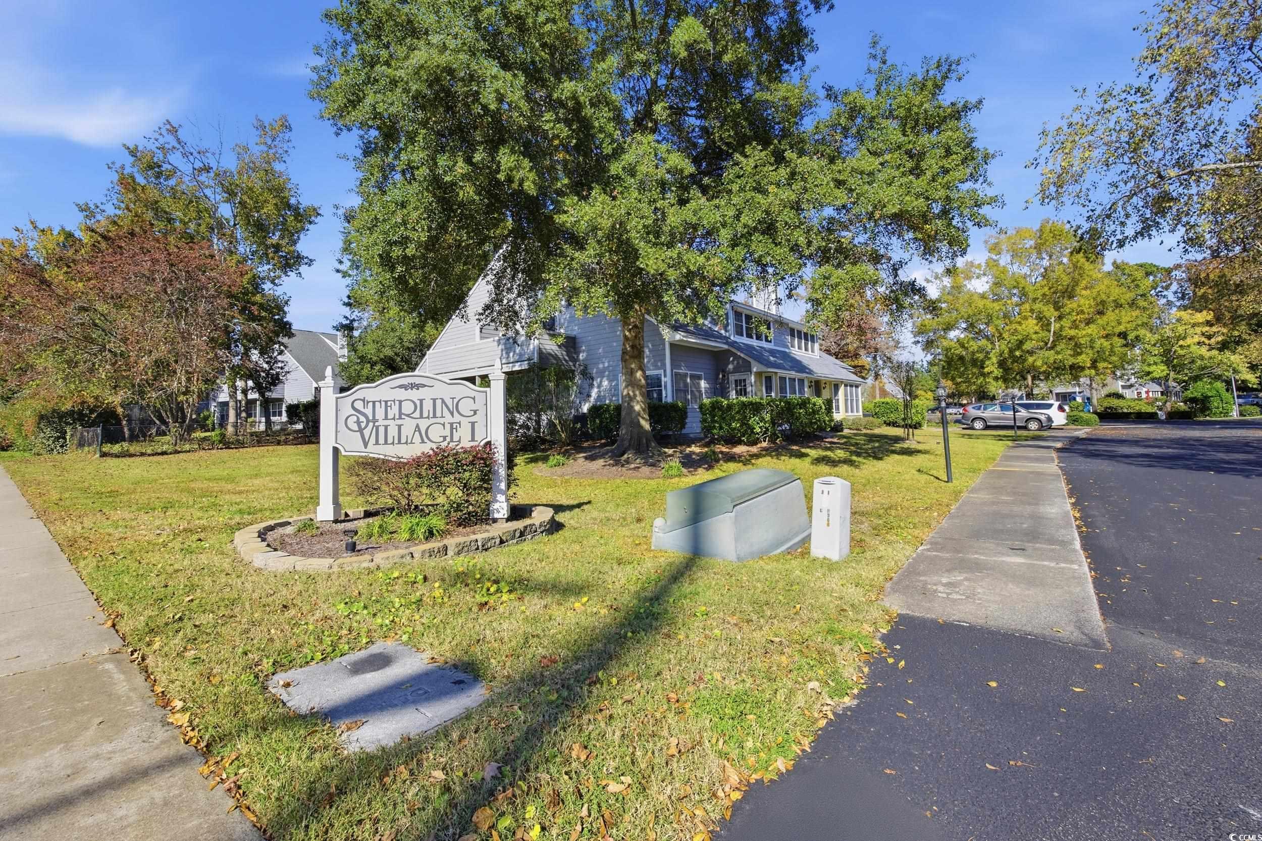 1200 Benna Drive, Unit 1C Myrtle Beach, SC 29577 - Photo 27 of 37 View of front of house with a front lawn