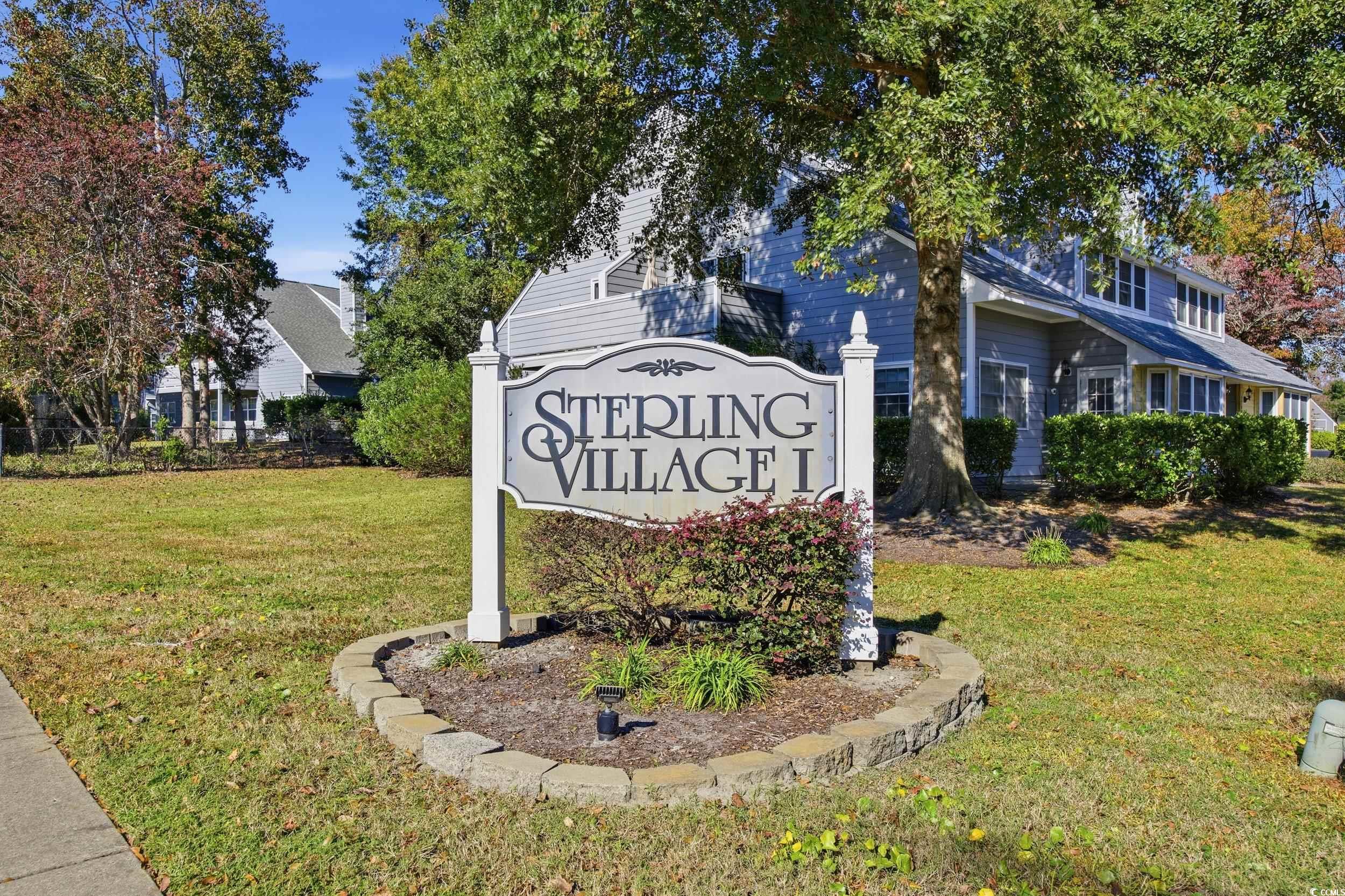 1200 Benna Drive, Unit 1C Myrtle Beach, SC 29577 - Photo 3 of 37 Community sign with a lawn