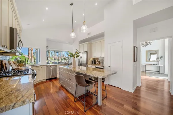 a kitchen with stainless steel appliances granite countertop a stove and a sink