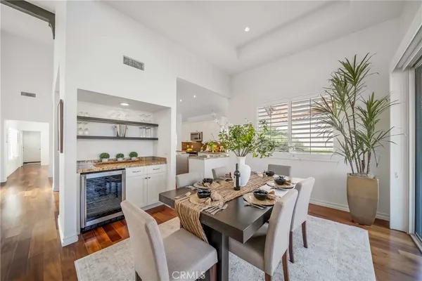 a view of hallway with livingroom and wooden floor