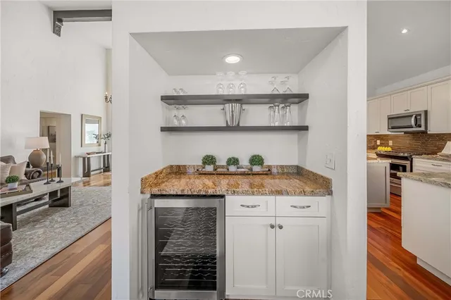 a bedroom with a bed lamp and a large window