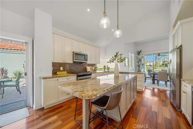 a view of a room with furniture and wooden floor