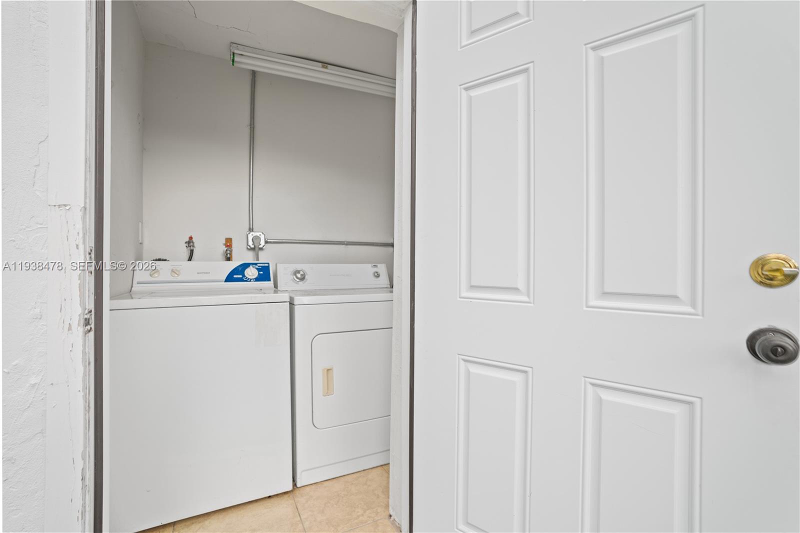 550 Northeast 68th Street, Unit 550 Miami, FL 33138 - Photo 15 of 15 a utility room with cabinets washer and dryer