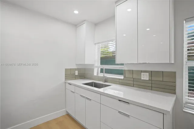 a kitchen with a sink and cabinets