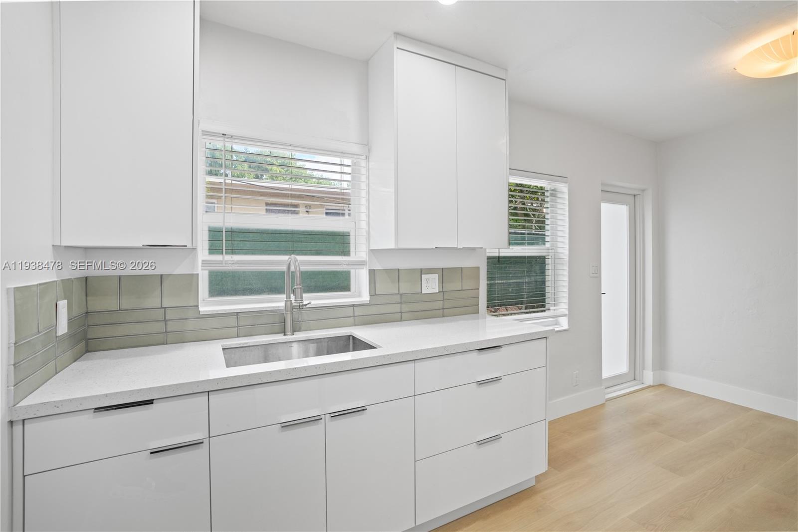 550 Northeast 68th Street, Unit 550 Miami, FL 33138 - Photo 4 of 15 a kitchen with a sink and large window