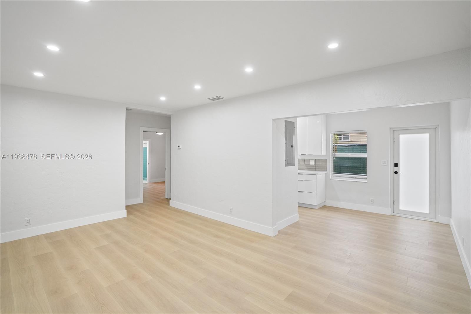 550 Northeast 68th Street, Unit 550 Miami, FL 33138 - Photo 5 of 15 an empty room with wooden floor and windows