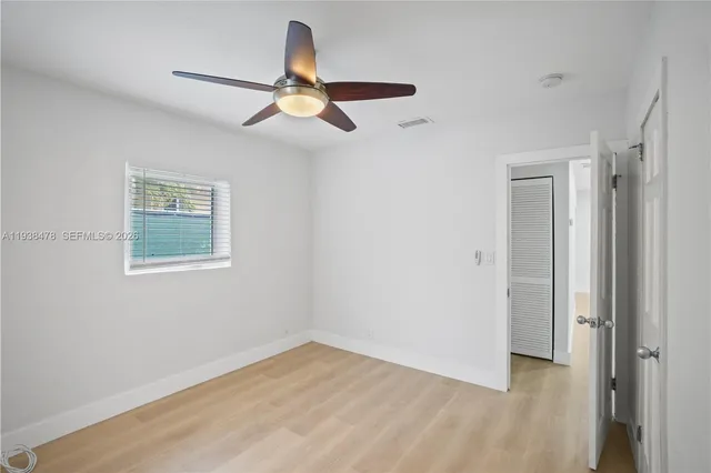 a view of empty room with ceiling fan
