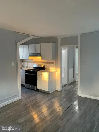 a kitchen with stainless steel appliances a stove a sink and a hard wood floor