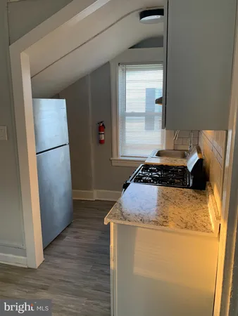 a kitchen with a refrigerator and a stove