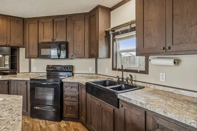 a kitchen with a sink stove and cabinets