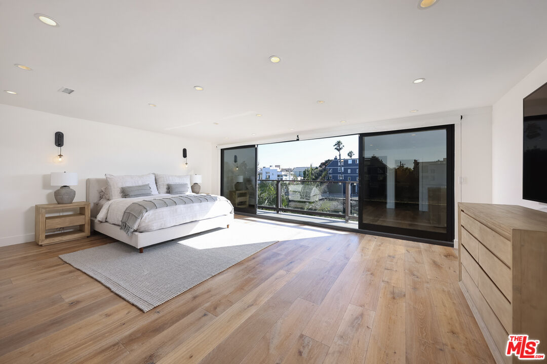 4811 Roma Court Marina del Rey, CA 90292 - Photo 30 of 57 a bedroom with a large bed and a large window