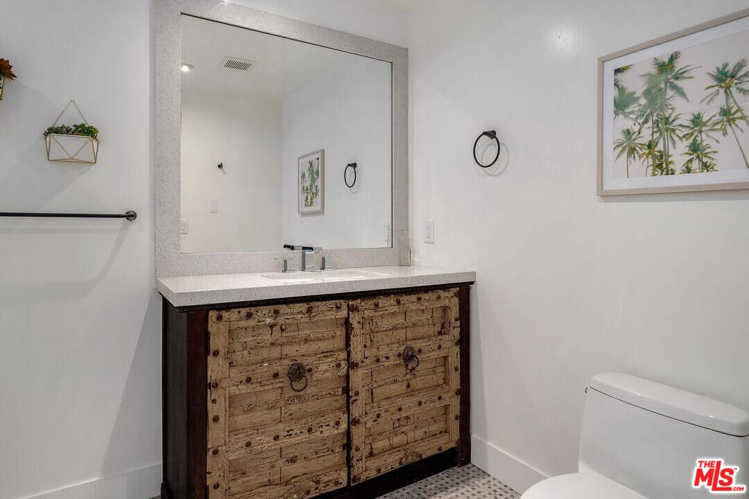 4811 Roma Court Marina del Rey, CA 90292 - Photo 41 of 57 a bathroom with a sink a toilet and a mirror