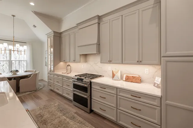 a kitchen with granite countertop white cabinets and white appliances