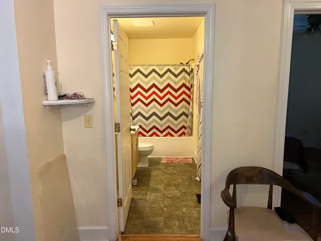 a bathroom with a glass door shower and a sink