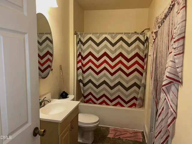 a bathroom with a sink and a curtain