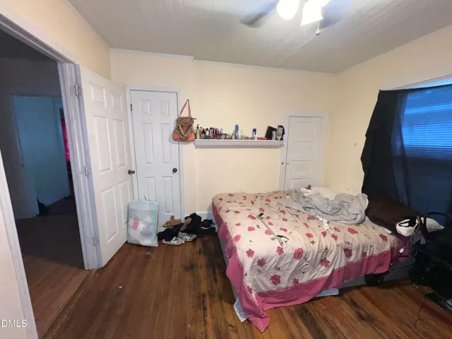 a bedroom with a bed and a mirror