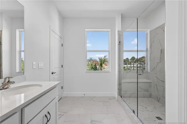 a white toilet sitting next to a white wall