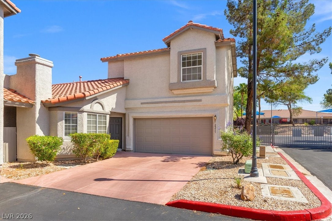2377 Ramsgate Drive Henderson, NV 89074 - Photo 1 of 25 A terracotta-tiled roof crowns this residence, featuring an attached garage and a neatly landscaped front yard.