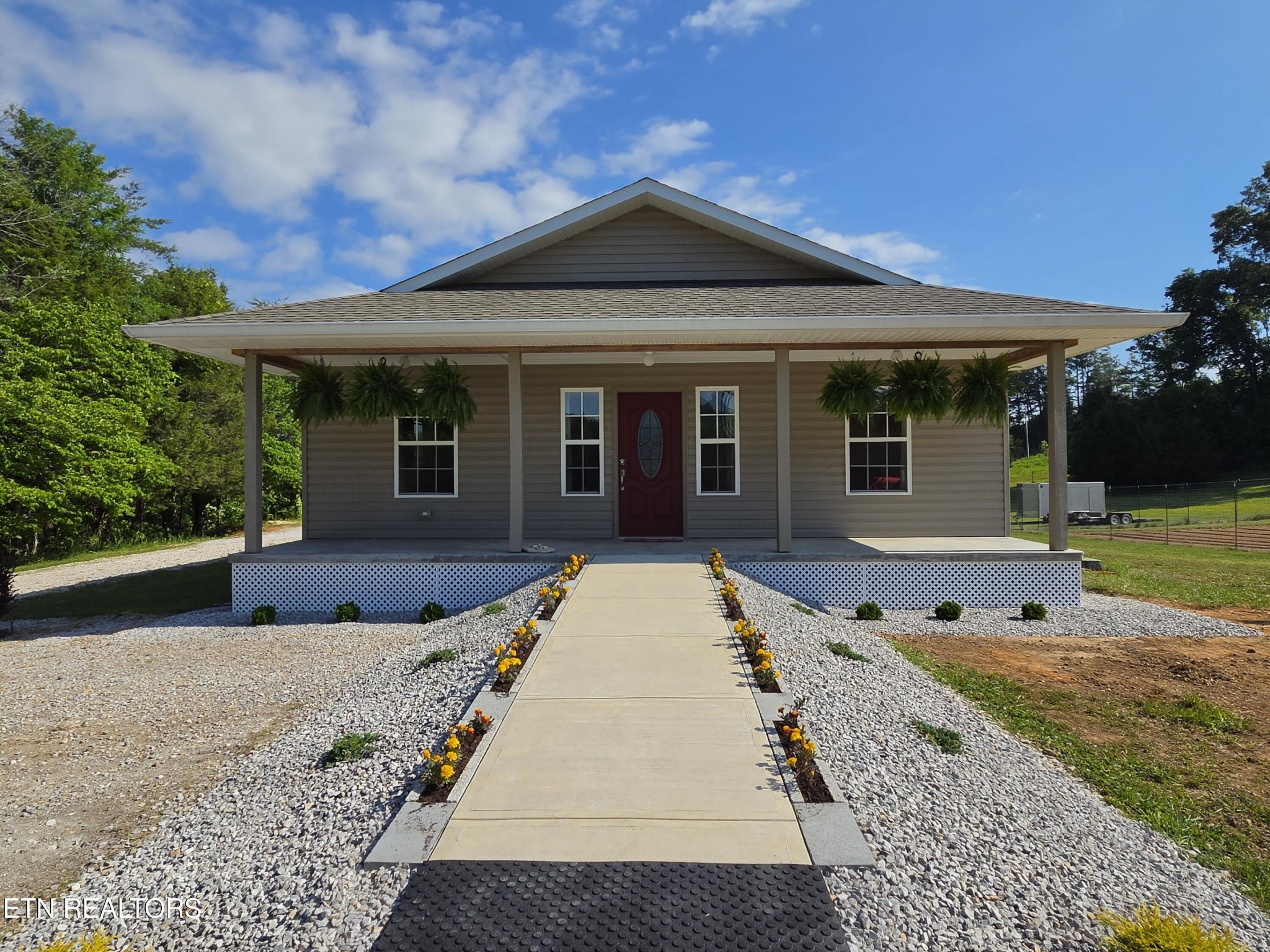 1518 Cummingsville And Sparkman Road Doyle, TN 38559 - Photo 1 of 58 a front view of a house with garden
