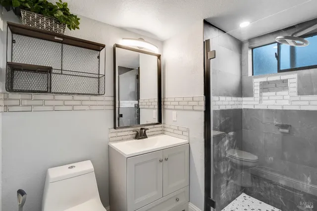 a view of staircase with furniture and windows