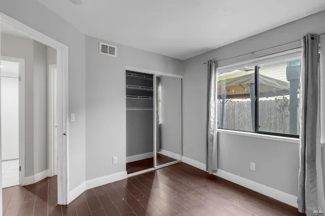 a bedroom with bed and a flat screen tv