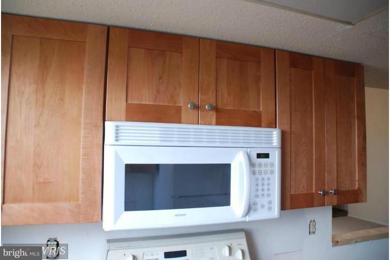119 Fort Evans Road Southeast, Unit E Leesburg, VA 20175 - Photo 2 of 29 a kitchen with a sink and cabinets