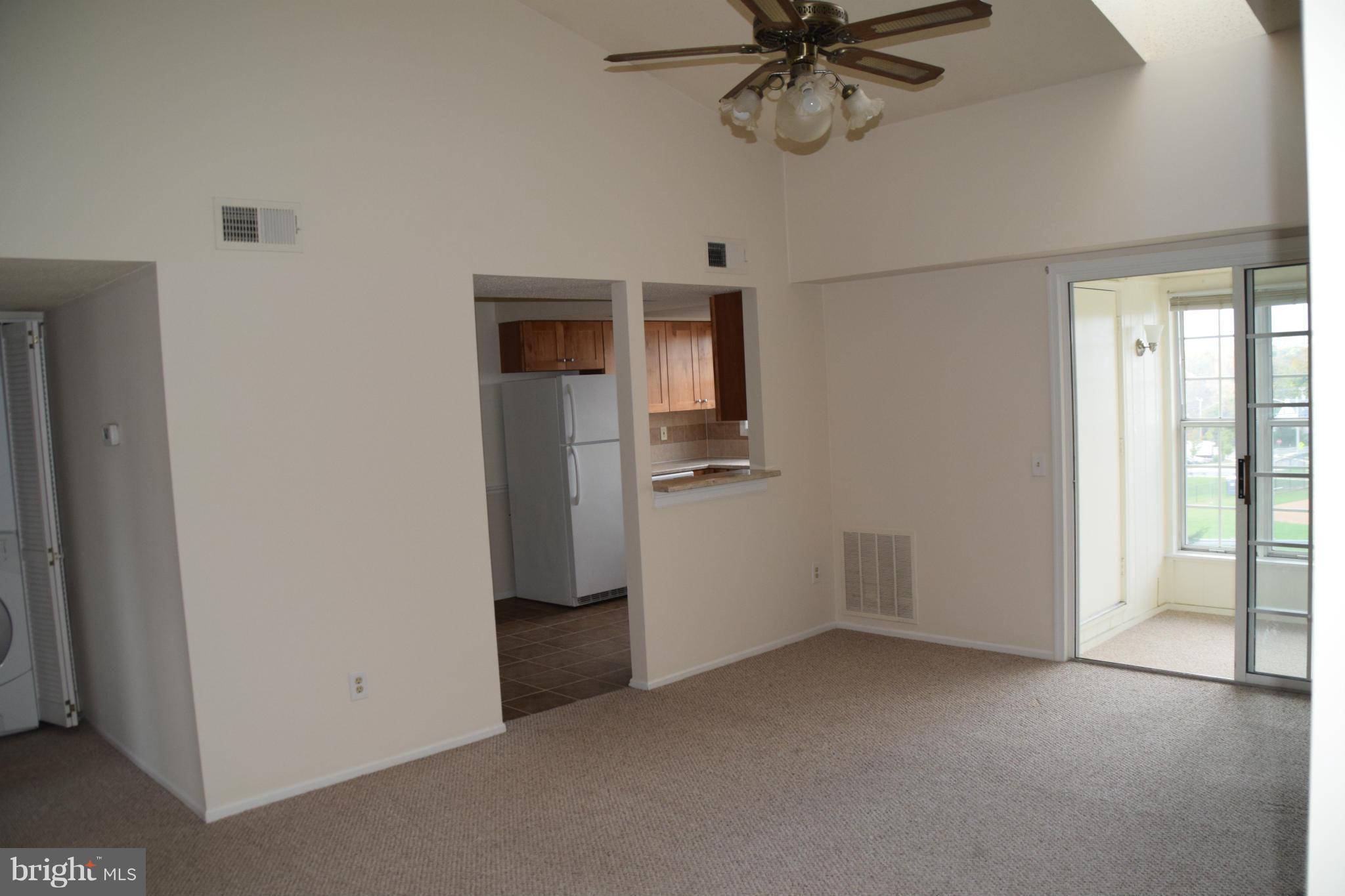 119 Fort Evans Road Southeast, Unit E Leesburg, VA 20175 - Photo 17 of 29 a view of a room with a ceiling fan and a window