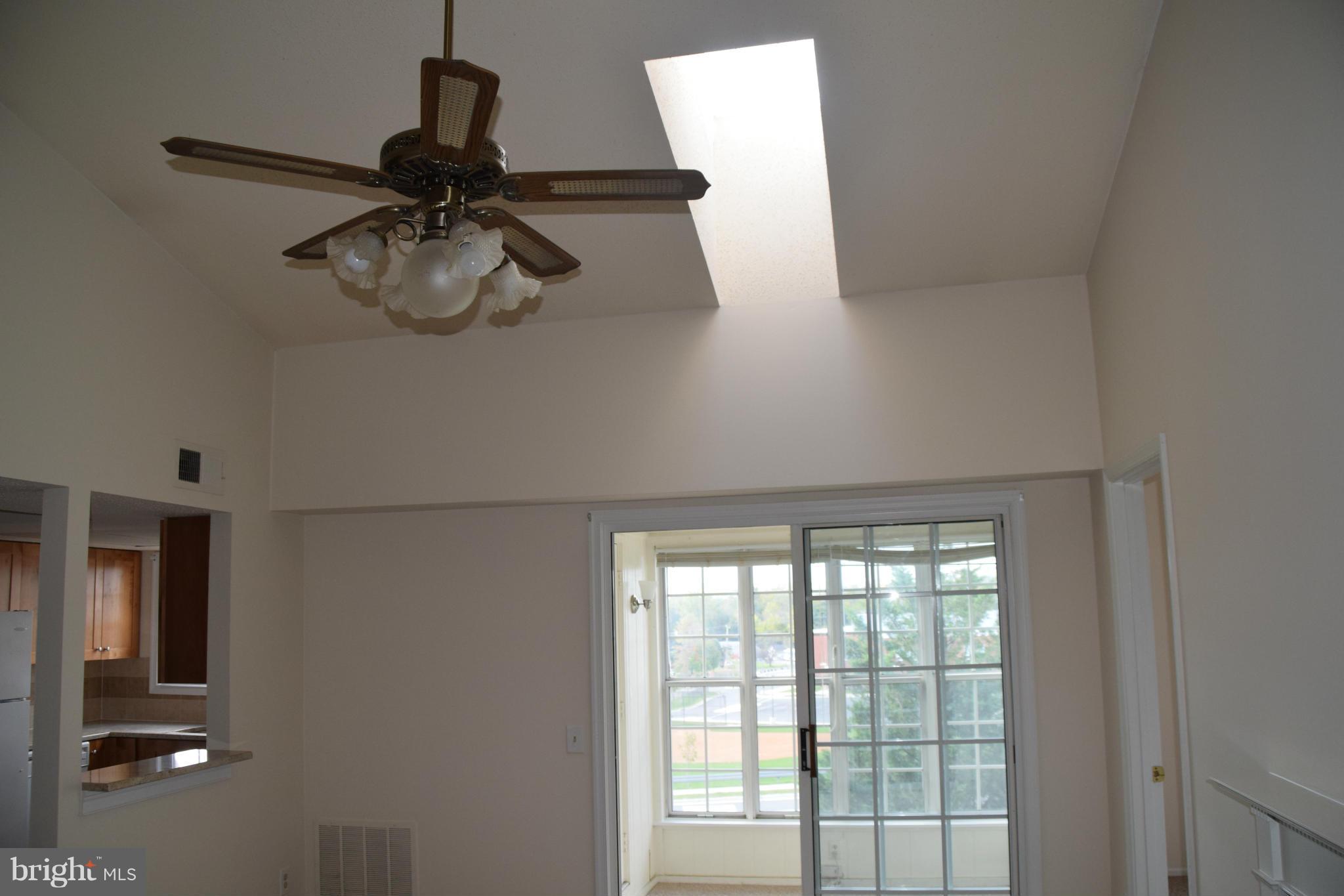 119 Fort Evans Road Southeast, Unit E Leesburg, VA 20175 - Photo 18 of 29 a view of a room with a ceiling fan and a window