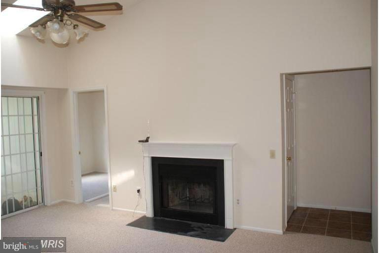 119 Fort Evans Road Southeast, Unit E Leesburg, VA 20175 - Photo 3 of 29 a view of an empty room with a fireplace