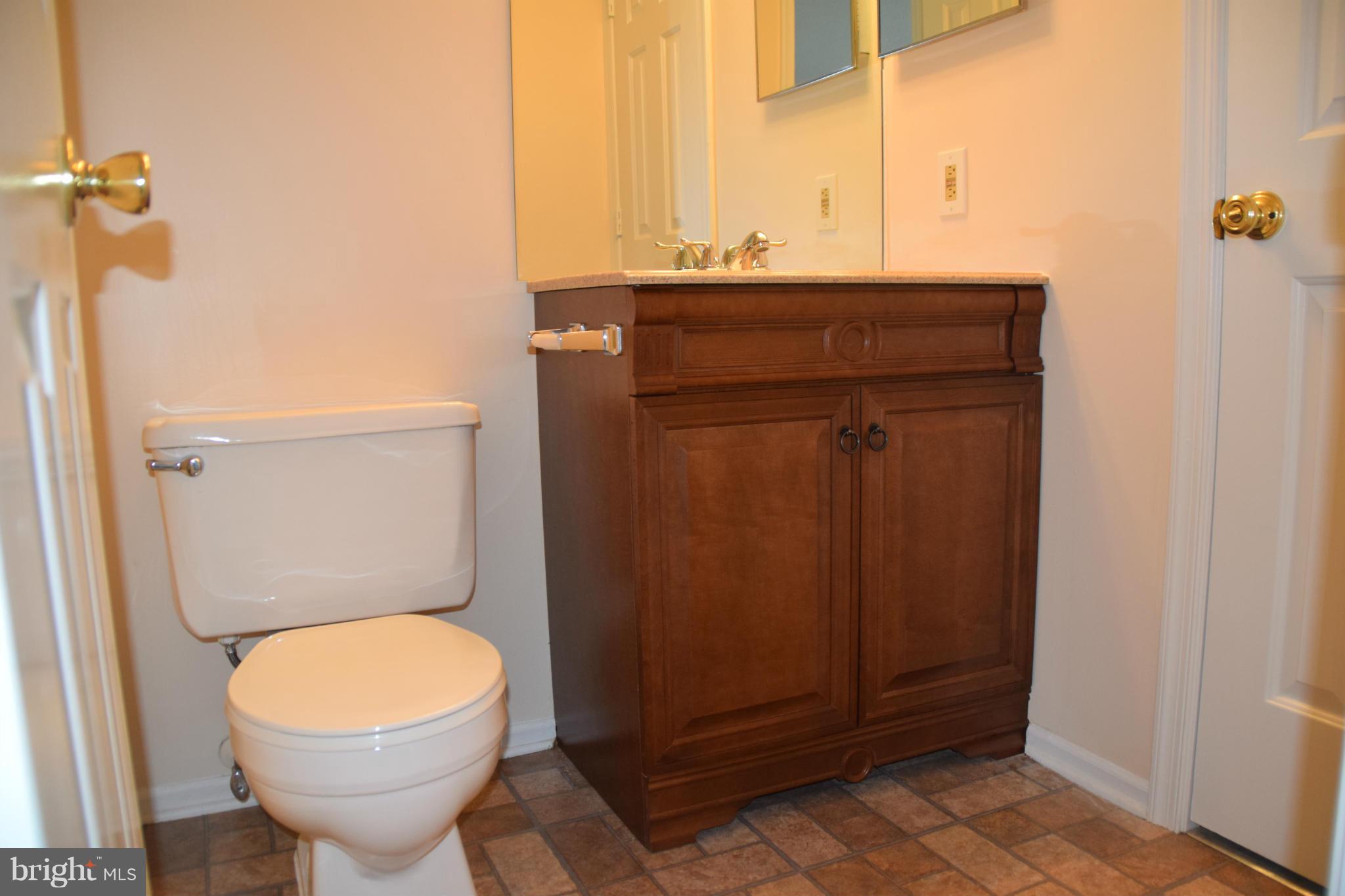 119 Fort Evans Road Southeast, Unit E Leesburg, VA 20175 - Photo 25 of 29 a bathroom with a toilet and a sink
