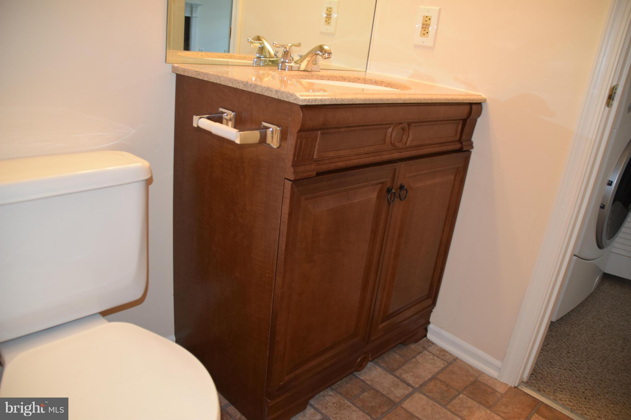 119 Fort Evans Road Southeast, Unit E Leesburg, VA 20175 - Photo 26 of 29 a bathroom with a toilet a sink and vanity