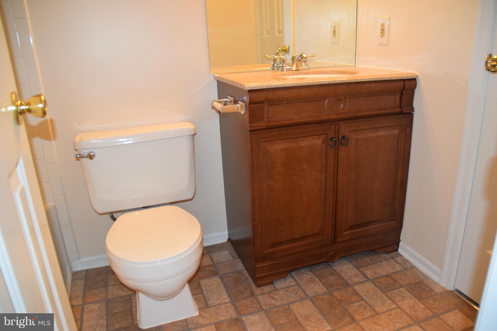 119 Fort Evans Road Southeast, Unit E Leesburg, VA 20175 - Photo 27 of 29 a bathroom with a toilet a sink and mirror