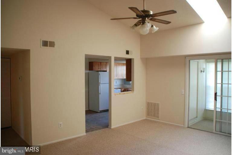 119 Fort Evans Road Southeast, Unit E Leesburg, VA 20175 - Photo 4 of 29 a view of a kitchen with a sink and a refrigerator