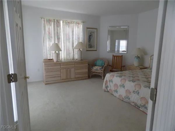 a bedroom with a bed and a television