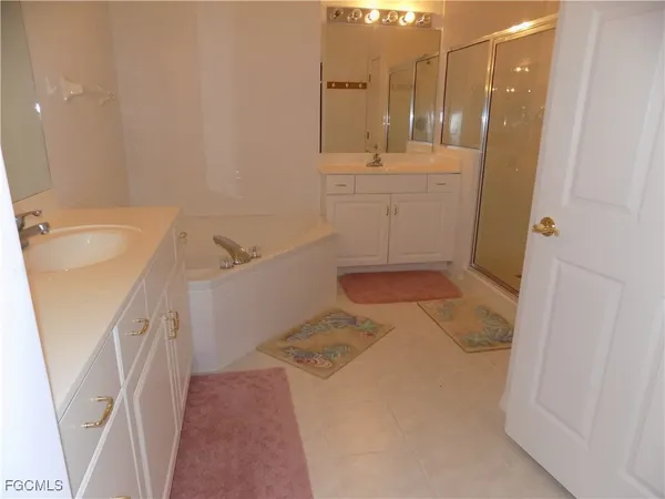 a bathroom with a bathtub sink and mirror