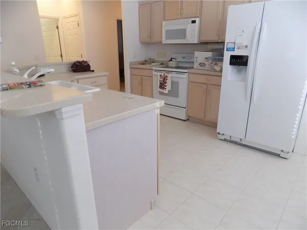 a kitchen with a sink stove and refrigerator