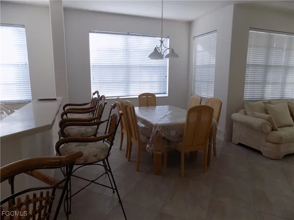 a dining room with furniture and window