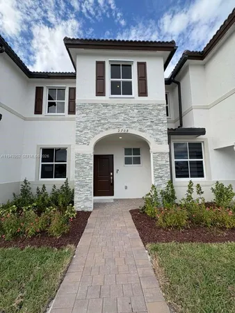 a front view of a house with a garden