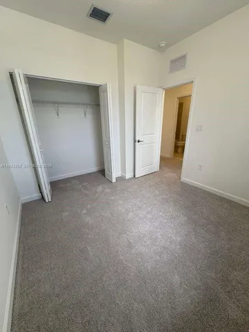 a view of an empty room and closet area