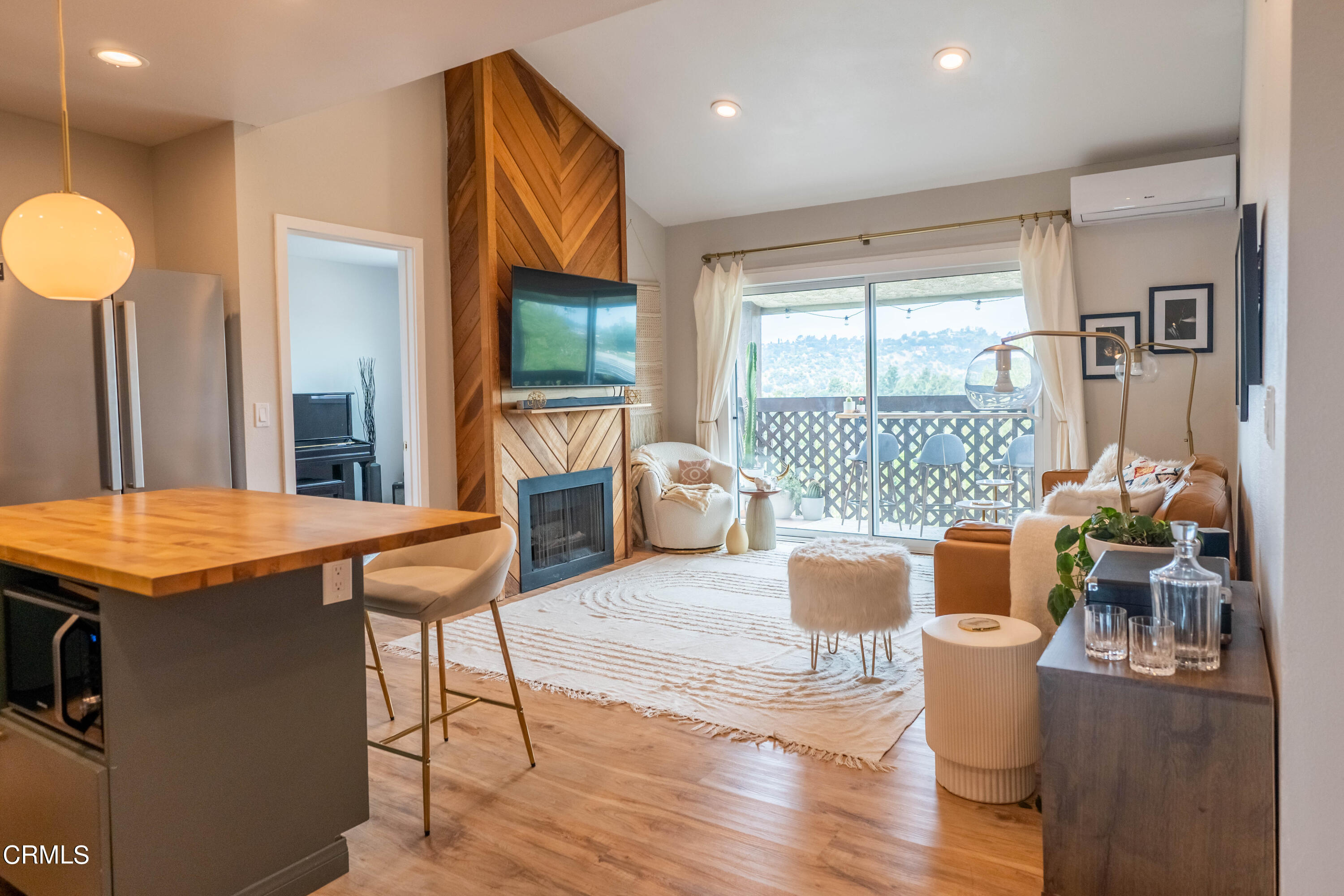5850 Benner Street, Unit 306 Los Angeles, CA 90042 - Photo 2 of 29 a living room with furniture a flat screen tv and a large window