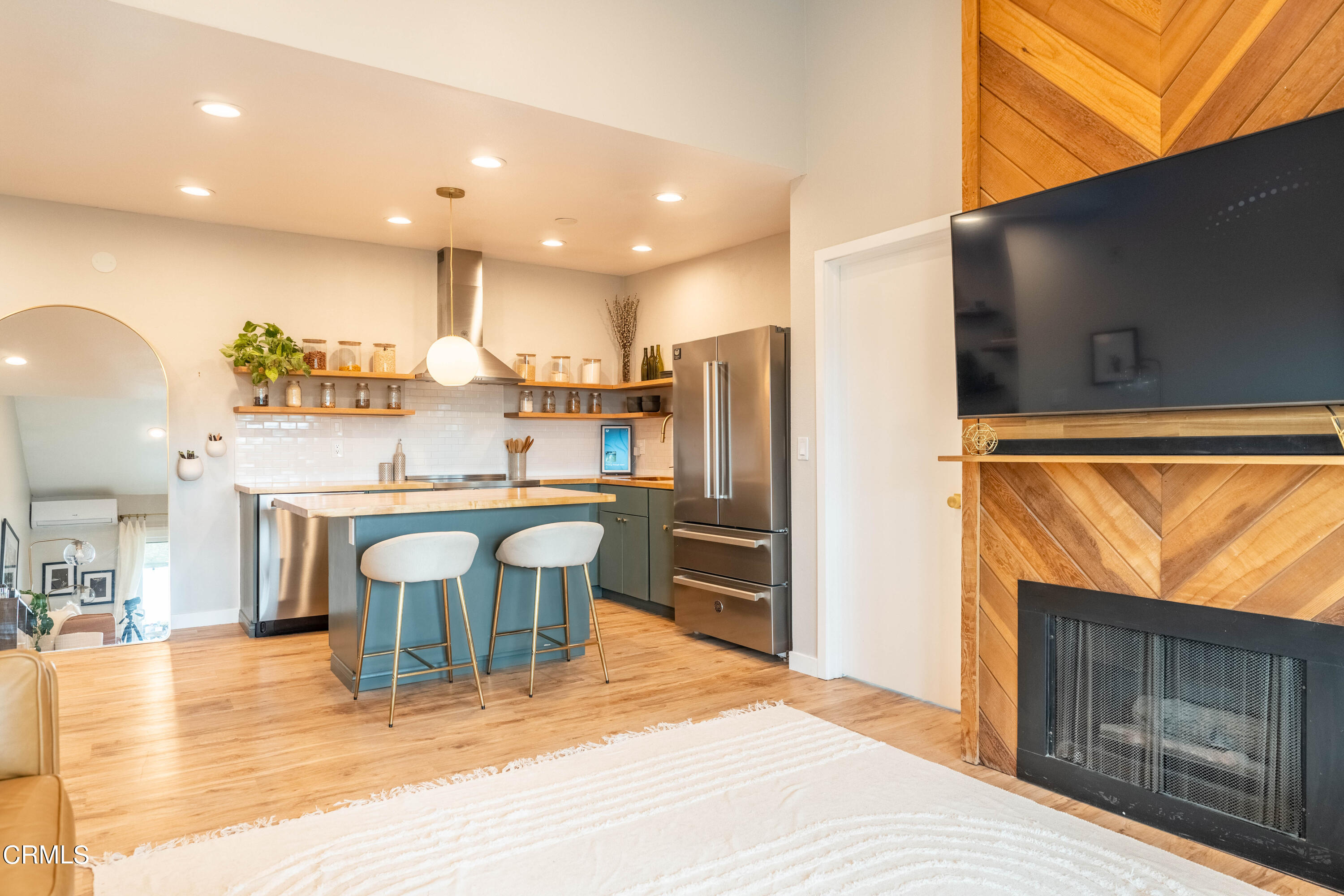 5850 Benner Street, Unit 306 Los Angeles, CA 90042 - Photo 4 of 29 a dining hall with stainless steel appliances granite countertop a refrigerator and a stove top oven with wooden floor