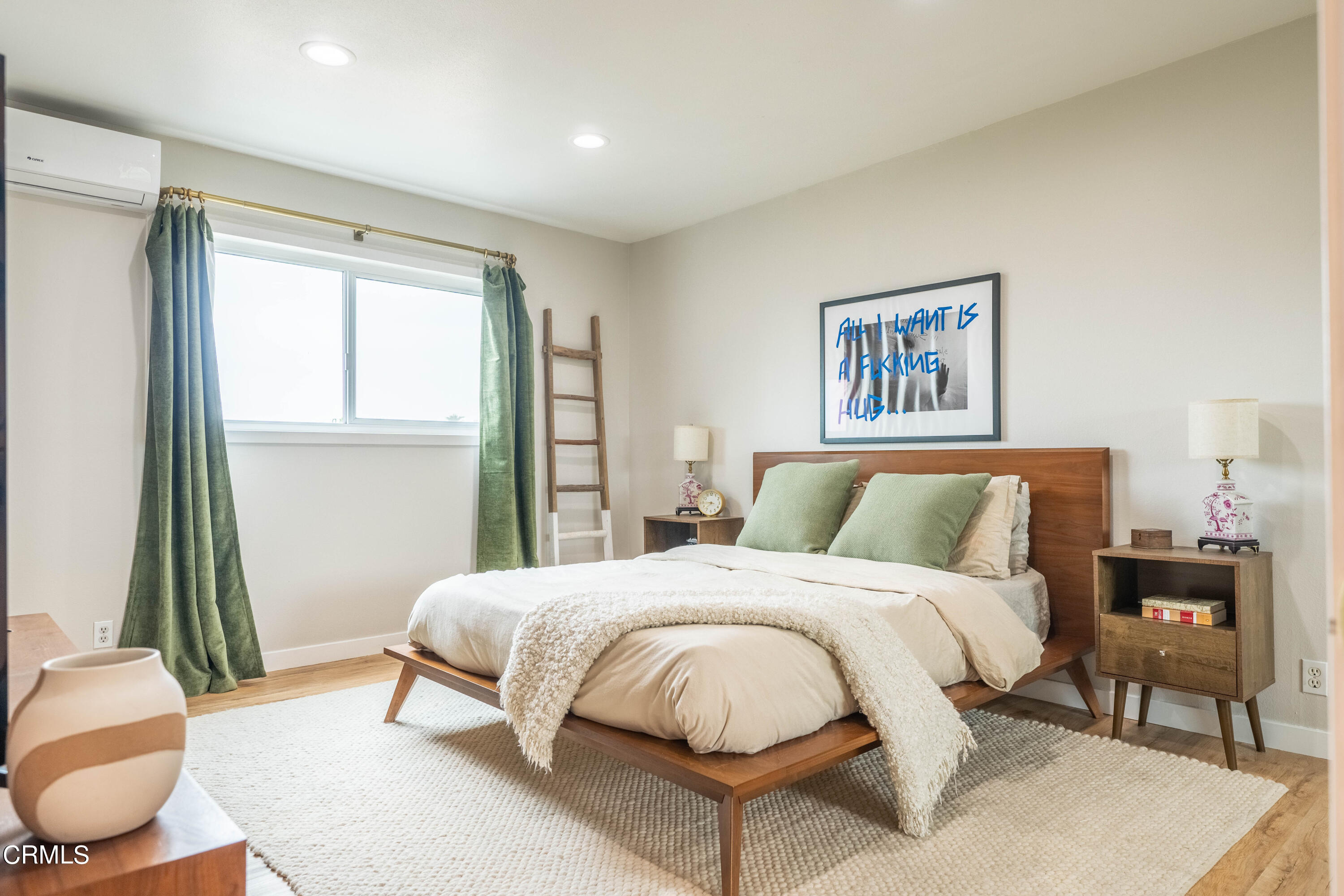 5850 Benner Street, Unit 306 Los Angeles, CA 90042 - Photo 8 of 29 a bedroom with a bed and a large mirror