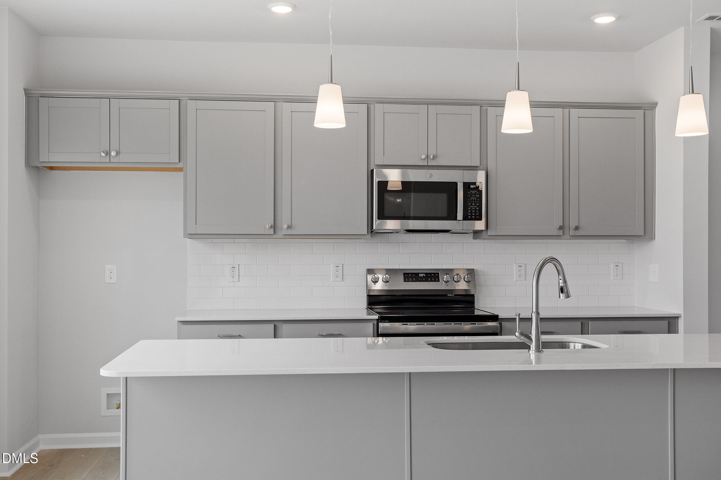 79 Osgood Street Angier, NC 27501 - Photo 14 of 31 a kitchen with stainless steel appliances a microwave a sink and cabinets