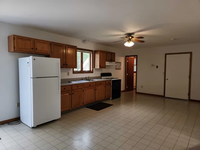 a kitchen with a refrigerator a stove top oven a sink and dishwasher